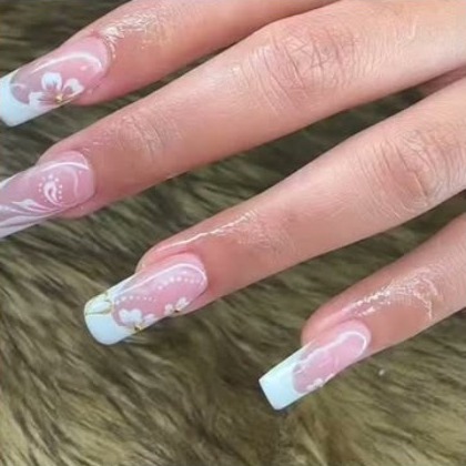 Long coffin nails with a white flower French tip and fine pearl detailing