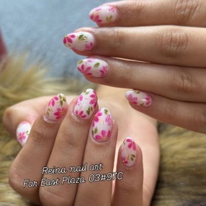 Pink and white painted florals on almond nails
